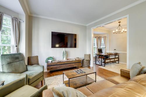 a living room with two couches and a table at Playroom and Home Office Family Retreat in Mauldin! in Mauldin