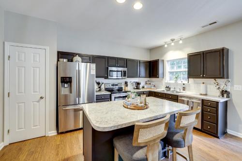 a kitchen with stainless steel appliances and a large island at Playroom and Home Office Family Retreat in Mauldin! in Mauldin