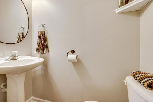 a white bathroom with a sink and a mirror at Playroom and Home Office Family Retreat in Mauldin! in Mauldin