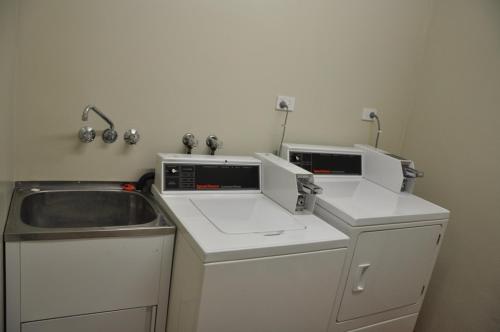 a small kitchen with a sink and a counter top at Lismore City Motor Inn in Lismore