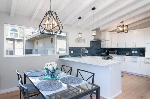 a kitchen with a table with chairs and a sink at 304 Ruby Ave B in Newport Beach
