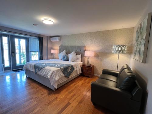 a large bedroom with a bed and a couch at Lee's Ocean Peek B & B in Stratford