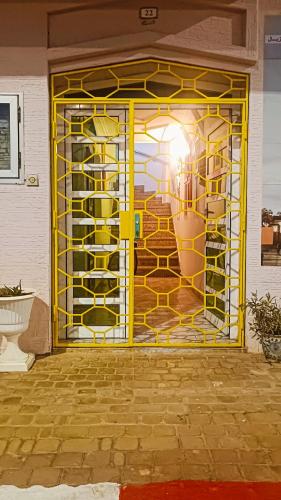a yellow door with a picture of a woman at Riad SULTANA lateral seaview in Saidia 
