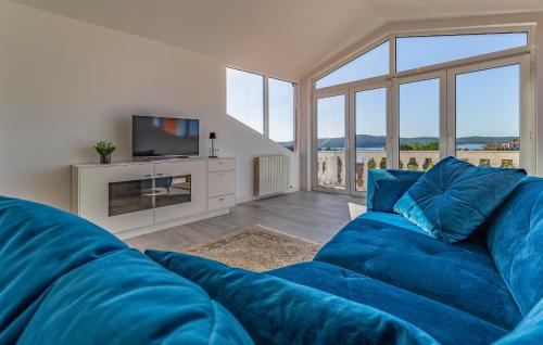 a living room with a blue couch and a tv at Nice Apartment In Medulin in Medulin