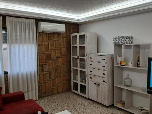 a living room with a book shelf and a dresser at San Juan in Alborache