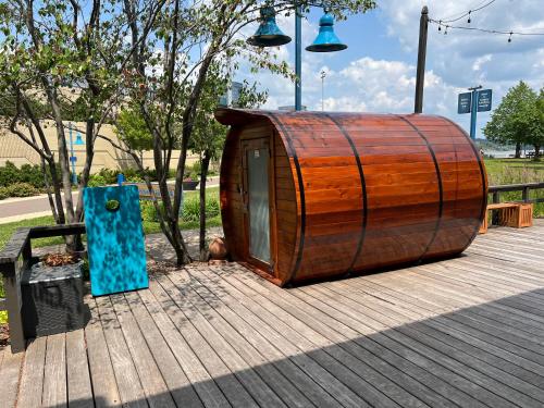 a large wooden barrel sitting on a wooden deck at Endion Station Inn by Heirloom Boutique Collection in Duluth