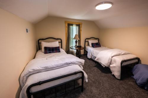 a room with two beds and a window at Relax & Unwind Cozy Farmhouse Near Natural Bridge State Park in Stanton