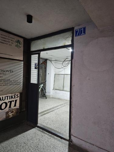 an empty room with a door open to a garage at Besa Apartment in Ferizaj