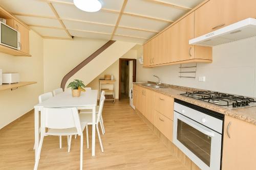 a kitchen with a table and a stove top oven at Casa Tina in Güimar