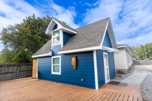 a blue house with a wooden deck at By the Bayou in Pensacola
