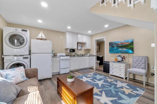 a living room with a couch and a kitchen at By the Bayou in Pensacola