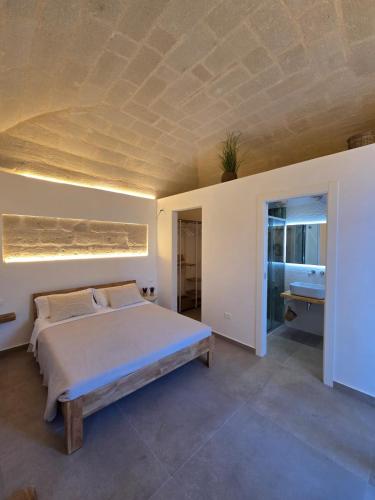 a bedroom with a large bed and a ceiling at Le Suite del Vicolo FAVIGNANA CENTRO in Favignana