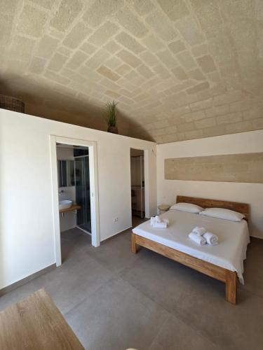 a bedroom with a bed and a coffered ceiling at Le Suite del Vicolo FAVIGNANA CENTRO in Favignana