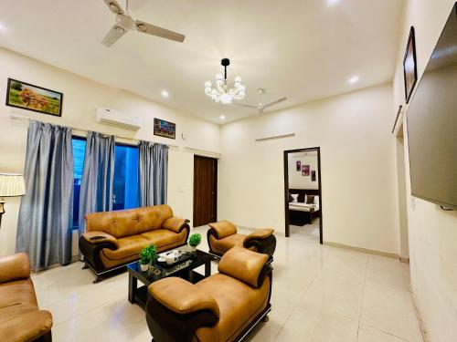a living room with couches chairs and a table at Oxygen Inn-Couple Friendly-Noida Sector51 in Noida