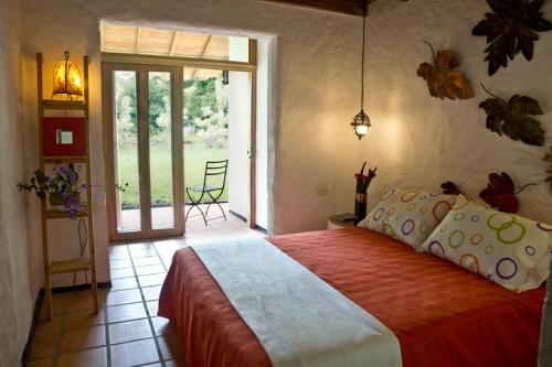a bedroom with a large bed and a sliding glass door at Beautiful and comfortable estate for 10 people from 450,000 in Quimbaya