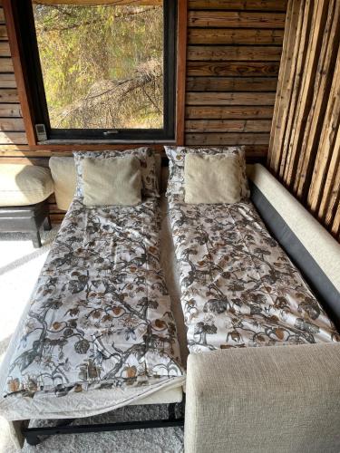 a bed in the back of a cabin at Forest Hideaway With Scenic View in Fiskå