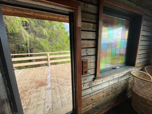 a door to a cabin with a view of a deck at Forest Hideaway With Scenic View in Fiskå
