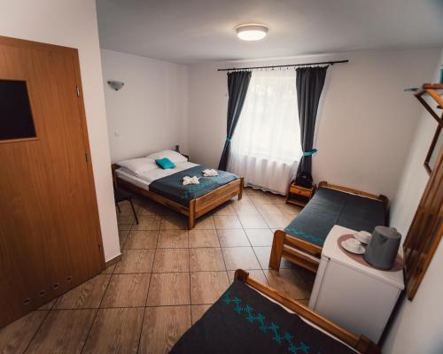 a small room with a bed and a couch at Šilainė Glamping & SPA, Padel court in Oszkinie