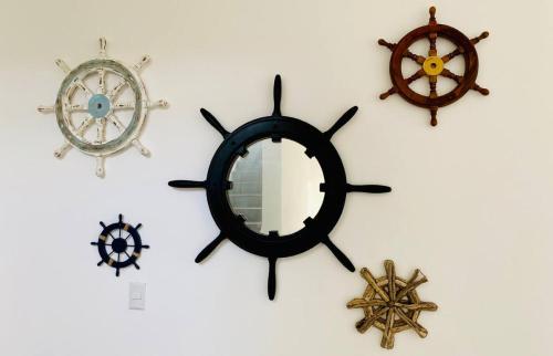 a group of clocks on a wall with a mirror at The sunrises are lovely, and the privacy is exceptional in Sipacate