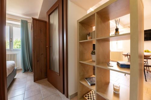 a room with wooden shelves and a dining room at I Madòna in Dongo