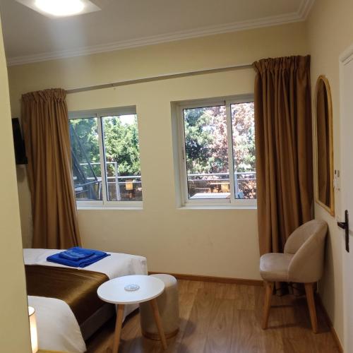 a hotel room with a bed and two windows at MDE Loisir Tanjis m in Tangier