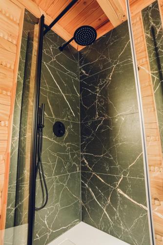 a shower with a glass door in a bathroom at Osada Kanada in Istebna