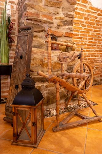 a wooden instrument sitting next to a brick wall at Pensiunea Bastion - La Strada - in Sighişoara