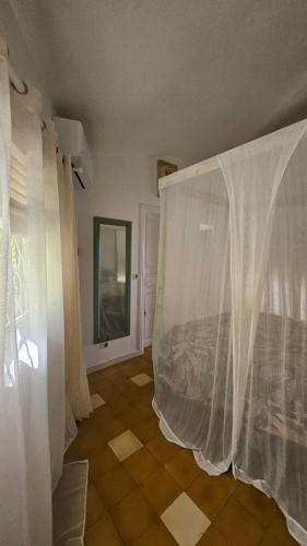 a room with white curtains and a window at Villa Guadeloupe Saint François Accès Mer Piscine IGUANA BAY - Villa Zagadi in Saint-François