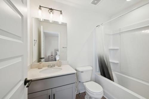 a white bathroom with a sink and a toilet at Arte Luxury Townhomes F6 I Comfy 2 Bed 25 Bath in Oak Grove