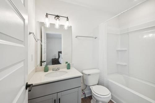 a white bathroom with a sink and a toilet at Arte Luxury Townhomes Q4 I Comfy 2 Bed 25 Bath in Oak Grove