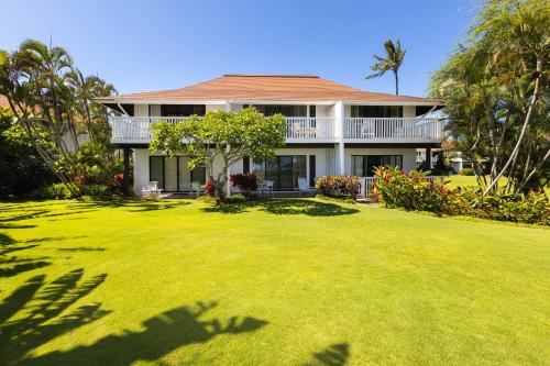 a large yard in front of a house at Kiahuna Plantation Resort Kauai by OUTRIGGER in Koloa