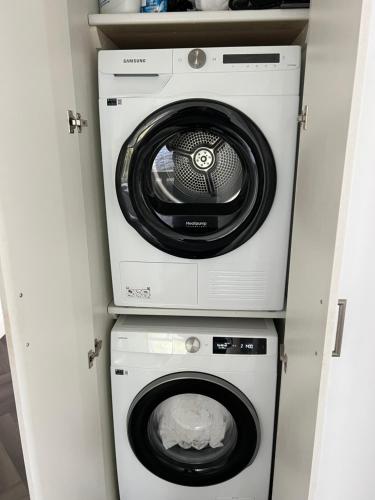 a washer and dryer in a small room at Salvation View 2 Bed Apartment in Hadleigh