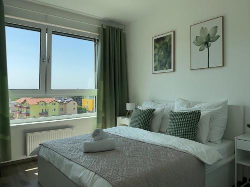 a bedroom with a large bed and a window at Cozy Modern Apartment, 20 mins to Center in Prague