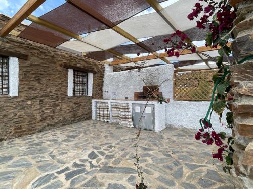 a room with a stone wall and a stone floor at Casa Crisantemo with sea view and pool in Adra in Las Hoyas del Barranco