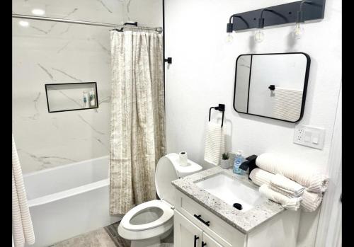 a white bathroom with a sink and a toilet at Kelly House in Pharr