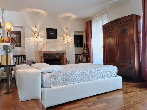 a bedroom with a white bed and a fireplace at Magnifico appartamento @Turin in Turin