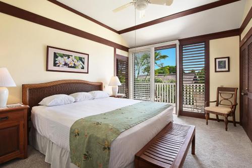 a bedroom with a large bed and a window at Kiahuna Plantation Resort Kauai by OUTRIGGER in Koloa