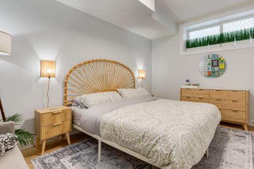 a bedroom with a large bed with a wooden headboard at Santuario Kensington - Inner City Escape in Calgary