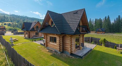 an overhead view of a log cabin with a black roof at Domki Biała i Czarna Owca in Witów
