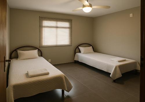 En eller flere senge i et værelse på Cobertura - Praia do Morro