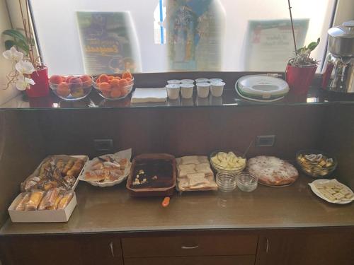 a counter topped with lots of different types of food at Regalpetra Hotel in Racalmuto