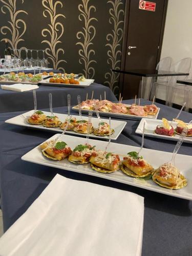 a table with many plates of food on it at Regalpetra Hotel in Racalmuto