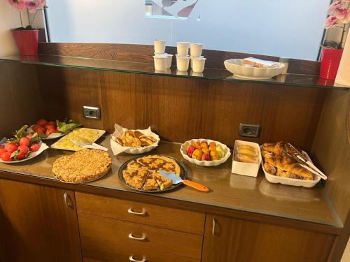 a buffet with different types of food on a counter at Regalpetra Hotel in Racalmuto