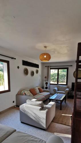 a living room with two couches and a table at Les Mûriers in La Ciotat