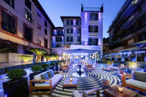 a patio with couches and tables in a building at LHP Hotel Santa Margherita Palace & SPA in Santa Margherita Ligure