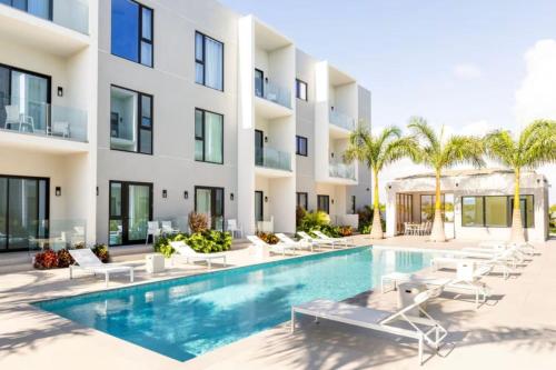 an exterior view of a building with a swimming pool at Luxury apartment in Grace Bay Beach in The Bight Settlements