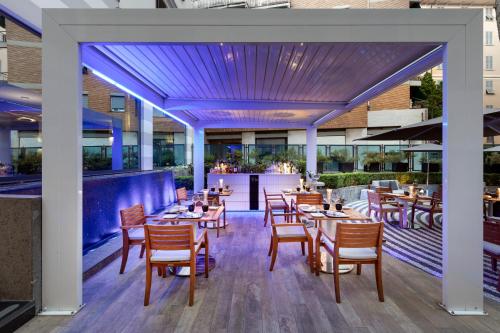 a restaurant with tables and chairs and a bar at LHP Hotel Santa Margherita Palace & SPA in Santa Margherita Ligure