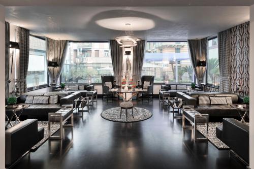 a lobby with couches and tables and windows at LHP Hotel Santa Margherita Palace & SPA in Santa Margherita Ligure