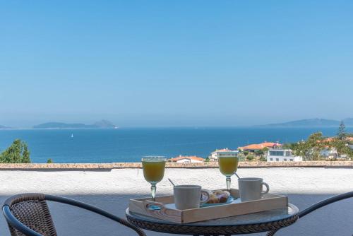 a tray of food and two glasses of orange juice at Villa Cies con Piscina in Vigo
