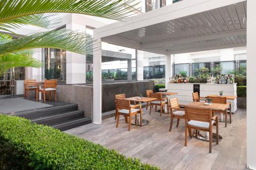 a patio with tables and chairs in a building at LHP Hotel Santa Margherita Palace & SPA in Santa Margherita Ligure